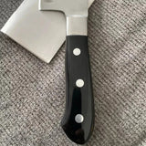 Black-handled axe on a textured surface