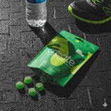 Green 'create' supplement package with green capsules on a black textured surface.