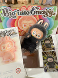 Fuzzy toy with 'Big into Energy' branding on a display stand with promotional materials.