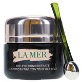 La Mer eye cream jar with a green applicator on a white background