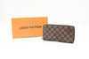 Louis Vuitton wallet and orange monogram box on a white background