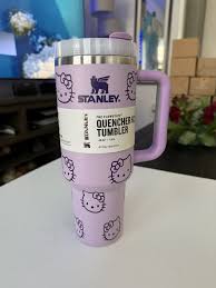 Pink tumbler with Hello Kitty design and Stanley branding on a white surface.