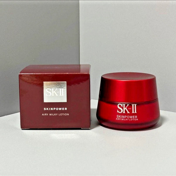 SK-II Skinpower Airy Milky Lotion jar and box on a gray background