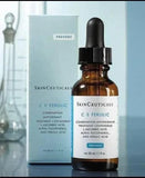 SkinCeuticals C E Ferulic serum bottle with dropper and packaging on a reflective surface.