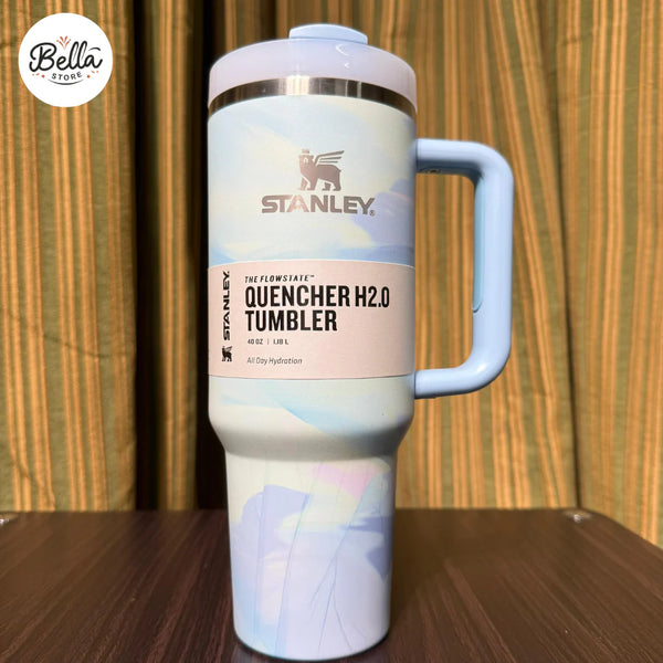 Stanley Quencher H2.0 tumbler with a colorful design on a wooden surface.
