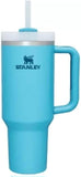 Turquoise Stanley tumbler with handle and straw lid on a white background