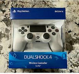 White PlayStation DualShock 4 controller in packaging on a marble surface