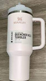 White Stanley Quencher H2.0 tumbler on a wooden surface